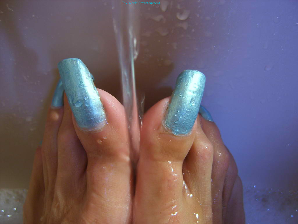 Seductive Emma — long metallic-blue toenails under cascading water